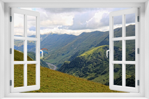 Fototapeta Naklejka Na Ścianę Okno 3D - paragliding high in the mountains of Georgia