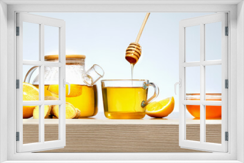 Fototapeta Naklejka Na Ścianę Okno 3D - Ginger tea with lemon and honey in glass cup on wooden table.