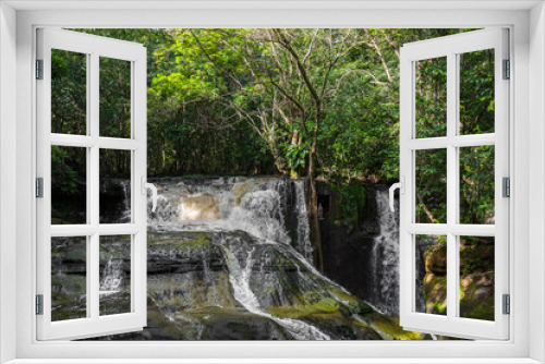 Fototapeta Naklejka Na Ścianę Okno 3D - Waterfalls flowing down rocks into the Amazon River below during daytime while surrounded by tropical lush rainforest & exotic green jungle foliage in the State of Amazonas, Brazil, South America