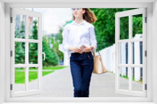 Portrait of a young beautiful business woman in glasses