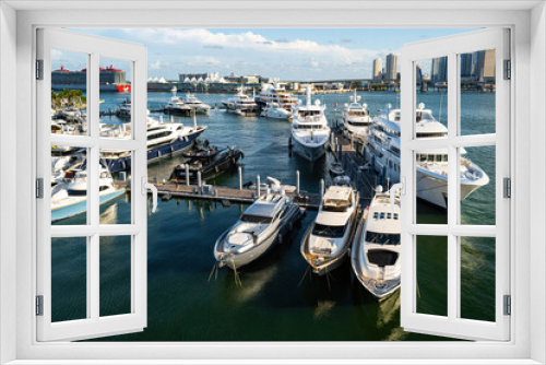 Fototapeta Naklejka Na Ścianę Okno 3D - View of the harbour. Luxury yachts docked in sea port. Marine parking of modern motor boats and blue water. Tranquility, relaxation and fashionable vacation.