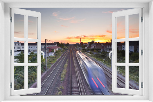Fototapeta Naklejka Na Ścianę Okno 3D - French train speeds off into the sunset.