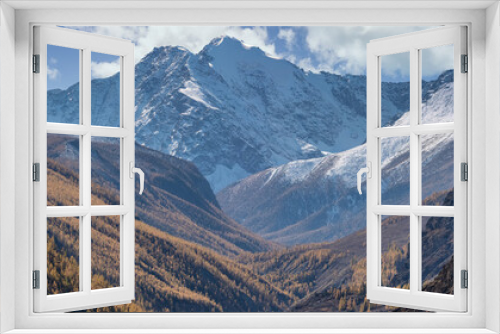 Fototapeta Naklejka Na Ścianę Okno 3D - Altai mountains covered with snow. Beautiful highland autumn panoramic landscape. Slopes covered with golden trees in the foreground. Blue cloudy sky as a background. Russia. Siberia