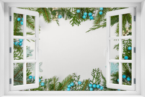 Fototapeta Naklejka Na Ścianę Okno 3D - Frame made of Christmas tree branches, snowflakes and blue berries.