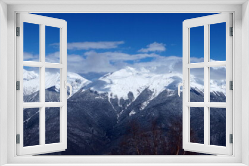 Fototapeta Naklejka Na Ścianę Okno 3D - Winter landscape in the mountains. Snow-capped mountain peaks, blue sky, ski slopes.
