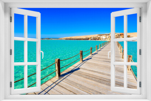 Fototapeta Naklejka Na Ścianę Okno 3D - Wooden Pier at Orange Bay Beach with crystal clear azure water and white beach - paradise coastline of Giftun island, Mahmya, Hurghada, Red Sea, Egypt.