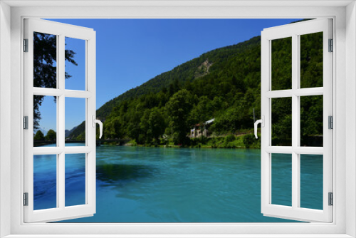 Fototapeta Naklejka Na Ścianę Okno 3D - Green fields and stunning touristic lake in Lauterbrunnen, Switzerland