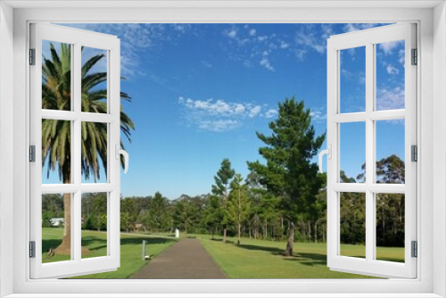 Fototapeta Naklejka Na Ścianę Okno 3D - Beautiful panoramic view of a park with green grass and tall trees and deep blue sky with light clouds in the background, Heritage park, Castle Hill, Sydney, New South Wales, Australia
