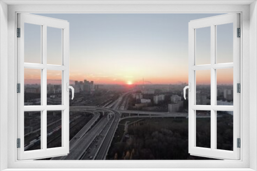 Fototapeta Naklejka Na Ścianę Okno 3D - Aerial view panorama of multi-level transport interchange in the center of the big city at dawn. Beautiful panoramic landscape infrastructure of modern city from great height