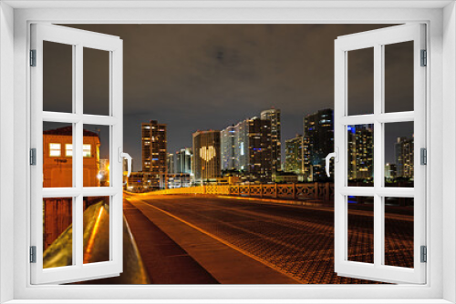 Fototapeta Naklejka Na Ścianę Okno 3D - Miami Florida, sunset panorama with colorful illuminated business and residential buildings and bridge on Biscayne Bay.