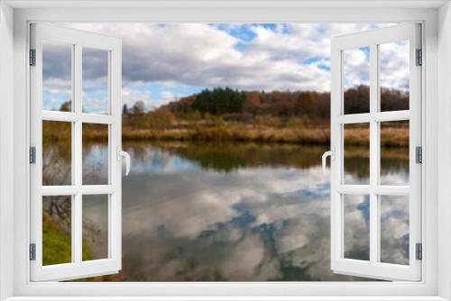Fototapeta Naklejka Na Ścianę Okno 3D - Panoramic landscape from the shore of the lake with colorful clouds and a swan in autumn