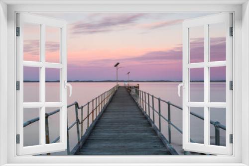 Fototapeta Naklejka Na Ścianę Okno 3D - A long exposure pastel sunset over the Robe wooden jetty lcoated in Robe South Australia on November 9th 2020