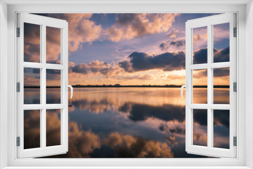 Fototapeta Naklejka Na Ścianę Okno 3D - Reflection on the water of a salt lake of a beautiful sunset with a sky full of clouds in Regional Park of the Salinas and Arenales de San Pedro del Pinatar, Murcia, Spain