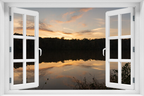 Fototapeta Naklejka Na Ścianę Okno 3D - Reflection like glass of a sunset and clouds on the surface of Yates Mill pond in Raleigh, North Carolina