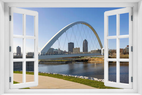 Fototapeta Naklejka Na Ścianę Okno 3D - Looking at the Des Moines Iowa skyline through the Woman of Achievement Bridge over the Des Moines River during daytime.