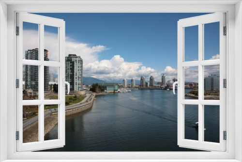 Fototapeta Naklejka Na Ścianę Okno 3D - View of Vancouver False Creek waterfront skyline with snow mountain during springtime Seen from Cambie Bridge in the downtown of Vancouver, British Columbia,  Canada.