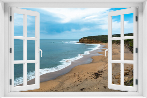 Fototapeta Naklejka Na Ścianę Okno 3D - Panoramic view from hill Bells beach cliff with surfers in water cloudy sky iconic surfing spot Australia Victoria state Great ocean road