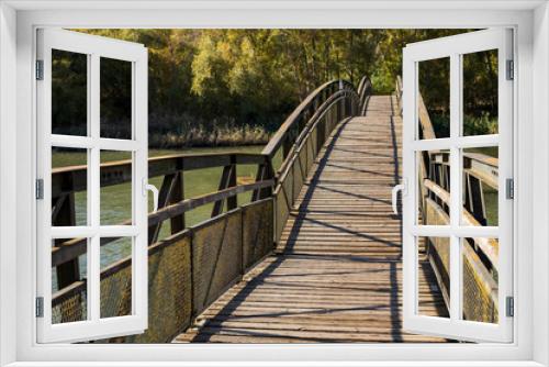 Fototapeta Naklejka Na Ścianę Okno 3D - Wooden bridge over a river.