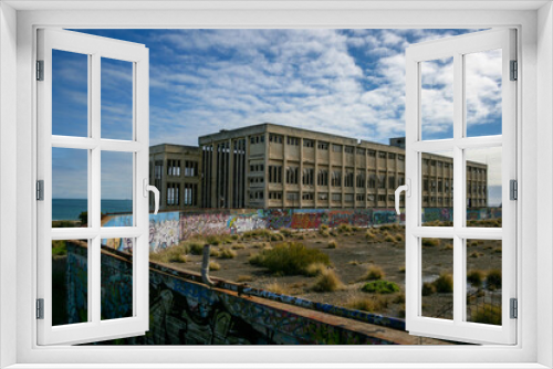 Fototapeta Naklejka Na Ścianę Okno 3D - Old Power Station in Fremantle with graffiti on sunny day with blue sky and some clouds, next to the beach, lost places, Perth, Western Australia