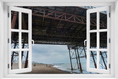 Fototapeta Naklejka Na Ścianę Okno 3D - Underneath Brighton Pier and structural details,in late winter,Brighton,East Sussex,England,United Kingdom.