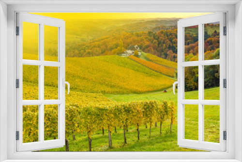 Fototapeta Naklejka Na Ścianę Okno 3D - Autumn landscape with South Styria vineyards,known as Austrian Tuscany,a charming region on the border between Austria and Slovenia with rolling hills,picturesque villages and wine taverns,at sunrise