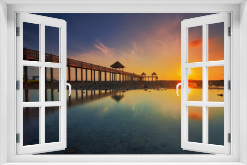Fototapeta Naklejka Na Ścianę Okno 3D - A long exposure picture of majestic sunrise with a jetty as a background at Tanjung Balau, Johore