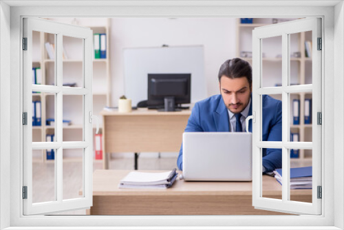 Young male businessman employee working in the office