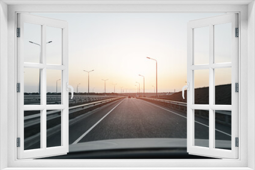 Fototapeta Naklejka Na Ścianę Okno 3D - Empty highway at dawn, view from driver's perspective