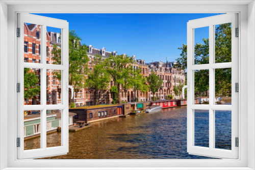 Fototapeta Naklejka Na Ścianę Okno 3D - Typical buildings and canal in Amsterdam by day, Netherlands