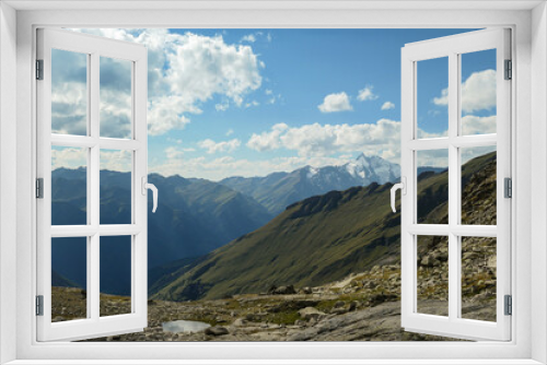 Fototapeta Naklejka Na Ścianę Okno 3D - Panoramic view from Hohe Sonnblick in Austrian Alps on Gro?glockner. The whole area is very steep and dangerous, with many lose stones. Green, steep meadows in front. Sunny day. Expedition