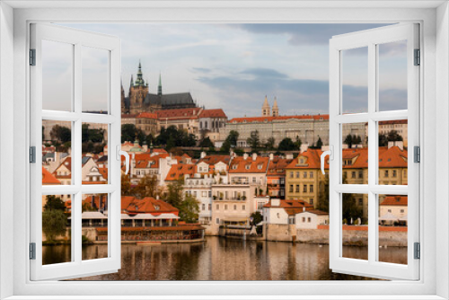 Fototapeta Naklejka Na Ścianę Okno 3D - View of the city of Prague with St. Vitus Cathedral on the hill and the Vltava river at dawn