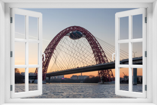 Fototapeta Naklejka Na Ścianę Okno 3D - A beautiful picturesque bridge in Moscow. Unusual architecture. Bridge on the background of sunset. Bridge over the river. Quiet winter evening