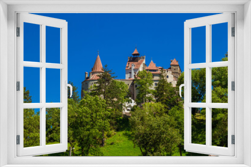 Fototapeta Naklejka Na Ścianę Okno 3D - Exciting trip to Brasov in summer sunny day. The medieval royal Castle of Bran known for the myth of Dracula in Transylvania, Romania. The castle is located on top of a mountain, day light. Travel