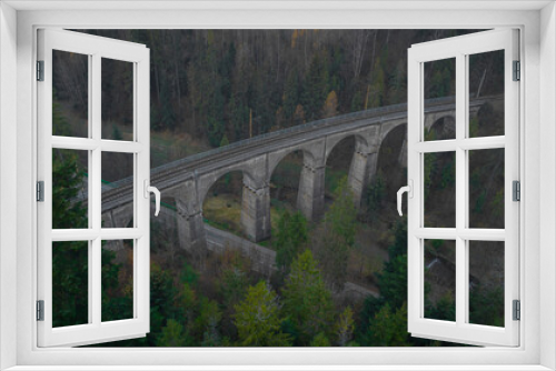 Fototapeta Naklejka Na Ścianę Okno 3D - Magical aerial panorama of mystical Glebce viaduct close to Wisla, Poland in late autumn weather. Mysterious train bridge.