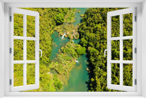 Fototapeta Naklejka Na Ścianę Okno 3D - The river in the rainforest among the green lush vegetation. Loboc River view from the top. Bohol, Philippines.