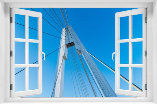 Fototapeta Naklejka Na Ścianę Okno 3D - Details of the cable-stayed bridge against the background of the blue sky.