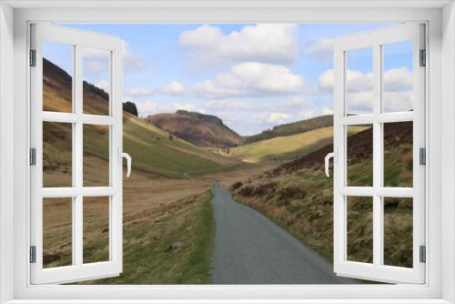 Fototapeta Naklejka Na Ścianę Okno 3D - A view down an isolated and remote Welsh mountain road in Gwynedd, UK.
