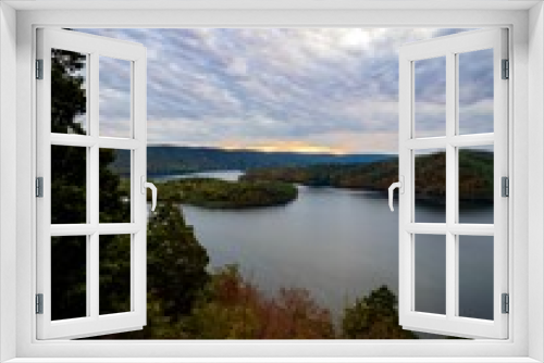Fototapeta Naklejka Na Ścianę Okno 3D - Hawn’s Overlook of Raystown Lake in the mountains of Pennsylvania in the fall right before sunset with a dramatic blue swirly sky with orange tones in it and water as smooth as glass.