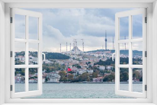 Fototapeta Naklejka Na Ścianę Okno 3D - Cityscape of Bosphorus strait with Camlica Mosque and ancient and modern buildings in Istanbul Turkey from ferry on a sunny day with background cloudy sky