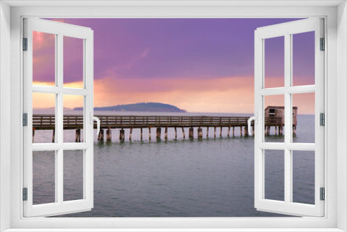 Fototapeta Naklejka Na Ścianę Okno 3D - Romantic view of a Wooden Pier  with birdwatching hut in Trasimeno lake in the purple light of the sunset, Magione,  Umbria, Italy.