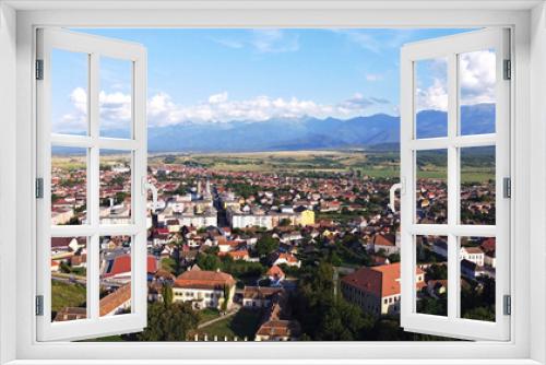 Fototapeta Naklejka Na Ścianę Okno 3D - Drone panoramic view of small town in Transylvania, with the Carpathian mountains in the back