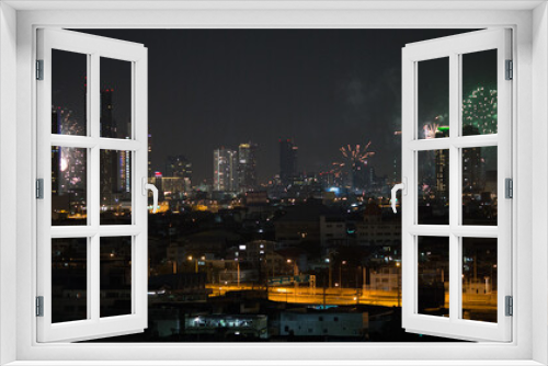 Fototapeta Naklejka Na Ścianę Okno 3D - The high angle background of the city view with the secret light of the evening, blurring of night lights, showing the distribution of condominiums, dense homes in the capital community