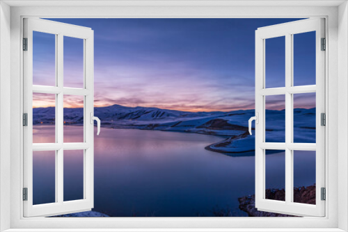 Fototapeta Naklejka Na Ścianę Okno 3D - Beautiful winter landscape. Panoramic view on the lake  and mountains peaks snow-covered  after sunset. 