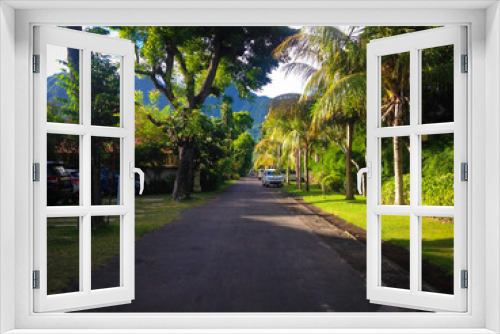 Fototapeta Naklejka Na Ścianę Okno 3D - Natural Beautiful Tropical Sunny Morning On The Road With Trees And Mountain View Of The Resort At Pemuteran, North Bali, Indonesia