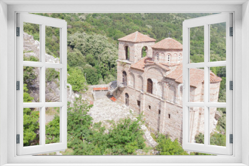 Fototapeta Naklejka Na Ścianę Okno 3D - Medieval Fortress Asen , on a hill in eastern Europe, Bulgaria. Bulgarian antique and heritage stronghold fortification on a rock. Aerial view of a holy place and monastery. Tourist place with forest.