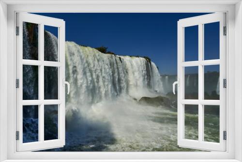 Fototapeta Naklejka Na Ścianę Okno 3D - Iguazu Falls or Iguacu Falls, on the border of Argentina and Brazil, are the largest waterfall in the world. Very high waterfall with white water in beautiful rain forest landscape in the jungle