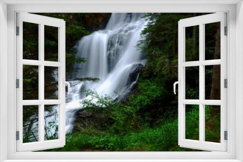 Fototapeta Naklejka Na Ścianę Okno 3D - gorgeous large waterfall in a green forest while hiking