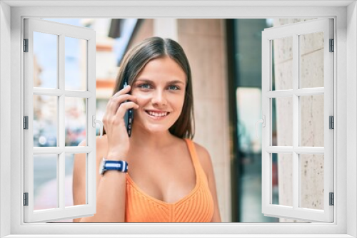 Young middle east girl smiling happy talking on the smartphone at the city.