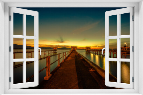 Fototapeta Naklejka Na Ścianę Okno 3D - The background of the bridge stretches into the sea, with twilight light in the morning, beautiful colors, sky wallpaper and refreshing surroundings.