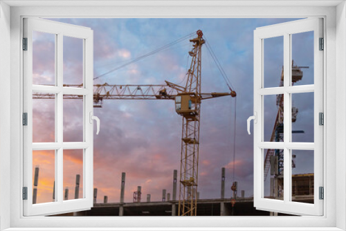 Fototapeta Naklejka Na Ścianę Okno 3D - Crane at a house construction